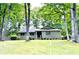 Charming single story home with lush green yard and mature trees surrounding the property at 1312 La Mesa Dr, Lawrenceville, GA 30043