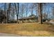 Charming single-story home with an inviting front yard surrounded by mature trees and a well-maintained lawn at 1312 La Mesa Dr, Lawrenceville, GA 30043