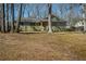 Charming single-story home with an inviting front yard surrounded by mature trees and a well-maintained lawn at 1312 La Mesa Dr, Lawrenceville, GA 30043
