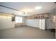 View of the spacious garage with built-in shelving, window, and a refrigerator at 1312 La Mesa Dr, Lawrenceville, GA 30043