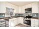 Beautiful kitchen features white cabinets, stainless appliances, and attractive backsplash at 1312 La Mesa Dr, Lawrenceville, GA 30043