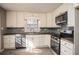 Well-lit kitchen features white cabinets, modern appliances, and stylish backsplash at 1312 La Mesa Dr, Lawrenceville, GA 30043