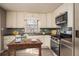 Modern kitchen features stainless appliances, decorative backsplash, and bright natural light at 1312 La Mesa Dr, Lawrenceville, GA 30043