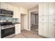 Efficient kitchen boasts updated appliances, light cabinets, and wood look floors at 1312 La Mesa Dr, Lawrenceville, GA 30043