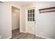 This mud room offers wood floors, coat rack, and access to a closet with white doors at 1312 La Mesa Dr, Lawrenceville, GA 30043