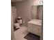 Bathroom featuring a toilet, patterned shower curtain, sink and mirror at 1470 Sweet Bottom Sw Cir, Marietta, GA 30064