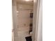 Bathroom with white tiled shower and toilet and a dark rug on the floor at 1470 Sweet Bottom Sw Cir, Marietta, GA 30064