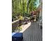 View from the deck of wooded backyard, plants, grill, and chairs at 1470 Sweet Bottom Sw Cir, Marietta, GA 30064