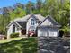 Charming two-story home with a manicured lawn, an attached two-car garage, and mature trees at 1470 Sweet Bottom Sw Cir, Marietta, GA 30064