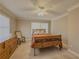 Comfortable bedroom with a ceiling fan, rocking chair, and two windows at 1894 Dogwood Ct, Snellville, GA 30078