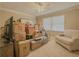 Bedroom is full of boxes, with a ceiling fan, and a chair at 1894 Dogwood Ct, Snellville, GA 30078