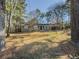 Charming single-story home with grey brick facade, mature trees, and a spacious front yard at 1894 Dogwood Ct, Snellville, GA 30078