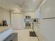 Well-lit kitchen featuring white cabinets, stainless steel appliances, and tiled flooring at 1894 Dogwood Ct, Snellville, GA 30078