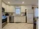 Functional kitchen featuring white cabinets, stainless steel appliances, and tile backsplash at 1894 Dogwood Ct, Snellville, GA 30078