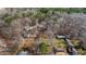 Aerial view of a neighborhood with multiple homes and wooded acreage at 3192 Highway 411 Ne, White, GA 30184