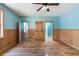 Bedroom featuring wood paneled wainscoting, hardwood floors, and multiple access doors at 3192 Highway 411 Ne, White, GA 30184
