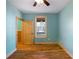 Bedroom with wood paneled wainscoting, hardwood floors, window and an access door at 3192 Highway 411 Ne, White, GA 30184