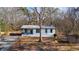 Charming single-story home with a cozy front porch and well-maintained landscaping at 3192 Highway 411 Ne, White, GA 30184