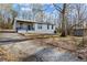 Single-story home featuring gravel drive, covered porch, and ample yard space at 3192 Highway 411 Ne, White, GA 30184