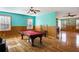 Spacious game room featuring a red felted pool table, wood paneled wainscoting, and hardwood flooring at 3192 Highway 411 Ne, White, GA 30184