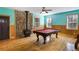Entertainment room with a stone fireplace and billiard table at 3192 Highway 411 Ne, White, GA 30184
