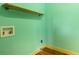 Mint colored laundry room with hookups and industrial style shelving is ready for appliances at 3192 Highway 411 Ne, White, GA 30184