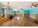 Spacious living room with hardwood floors, wainscoting, and stylish light fixtures at 3192 Highway 411 Ne, White, GA 30184