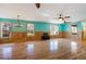 Bright living room featuring hardwood floors, wainscoting, and multiple windows at 3192 Highway 411 Ne, White, GA 30184