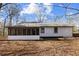 The house is white with black trim, a metal roof, and a screened-in porch in the back at 3192 Highway 411 Ne, White, GA 30184