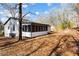 A charming white home featuring a screened-in porch and lush, wooded surroundings at 3192 Highway 411 Ne, White, GA 30184