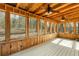 Bright enclosed sun room with ceiling fans and tranquil wooded views at 3192 Highway 411 Ne, White, GA 30184