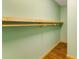 Walk-in closet with wood shelving, hanging rods, and faux-wood flooring at 3192 Highway 411 Ne, White, GA 30184