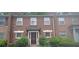 Charming brick townhome featuring a covered entryway and well-maintained landscaping at 3307 York Pl, Decatur, GA 30032