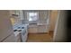 Traditional kitchen featuring white cabinets, standard appliances, and a bright window at 3307 York Pl, Decatur, GA 30032