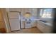 Bright kitchen with white cabinets, countertops, and appliances at 3307 York Pl, Decatur, GA 30032