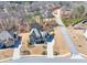 Stunning aerial view of a two-story home with a well-manicured lawn and tree-lined street at 4590 Gablestone Xing, Hoschton, GA 30548