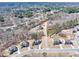 An aerial view of a suburban neighborhood showcasing beautiful homes and well-maintained streets at 4590 Gablestone Xing, Hoschton, GA 30548