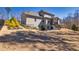 Spacious backyard with large trees, a tiered deck, and black iron fencing at 4590 Gablestone Xing, Hoschton, GA 30548