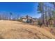Expansive backyard with mature trees and iron fence surrounding the property at 4590 Gablestone Xing, Hoschton, GA 30548