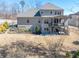 Large backyard featuring mature trees, tiered decks, and iron fencing at 4590 Gablestone Xing, Hoschton, GA 30548