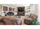 Finished basement boasts a stone fireplace, large sectional sofa, wet bar, and modern finishes at 4590 Gablestone Xing, Hoschton, GA 30548
