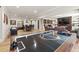 Spacious basement featuring hardwood floors, game tables, a wet bar, and a fireplace at 4590 Gablestone Xing, Hoschton, GA 30548