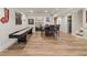 Finished basement features a shuffleboard table, dining table, and access to additional rooms at 4590 Gablestone Xing, Hoschton, GA 30548