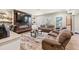 This basement has a fireplace, wood floors, a wet bar, and multiple sofas at 4590 Gablestone Xing, Hoschton, GA 30548