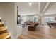 The finished basement features a wet bar, multiple sofas, wood floors, and a fireplace at 4590 Gablestone Xing, Hoschton, GA 30548