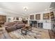 Finished basement featuring a large sectional sofa, fireplace, wet bar, and entertainment area at 4590 Gablestone Xing, Hoschton, GA 30548