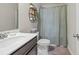Bathroom with a shower, sink, toilet, shelves, and a decorative swan at 4590 Gablestone Xing, Hoschton, GA 30548