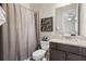 Clean bathroom featuring modern vanity, granite countertop and decorative mirror and accessories at 4590 Gablestone Xing, Hoschton, GA 30548