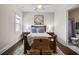 Well-lit bedroom with a decorative rug, natural light, and an en suite bathroom at 4590 Gablestone Xing, Hoschton, GA 30548