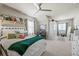 Bedroom with a full-sized bed, ceiling fan, dresser, and built in shelving at 4590 Gablestone Xing, Hoschton, GA 30548